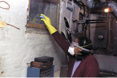 Properly attired for mold clean-up.