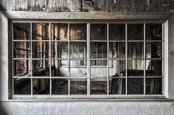 looking through window of fire damaged house