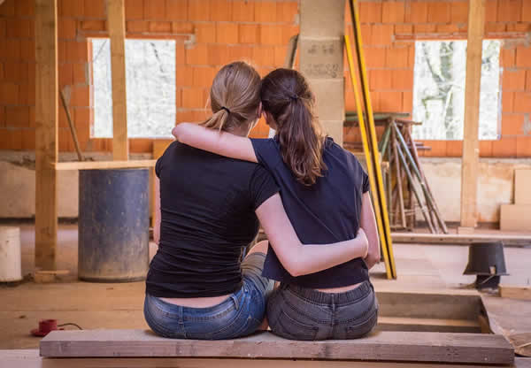 girlfriends sitting and looking at the reno they are doing