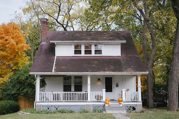 small white house with black roof