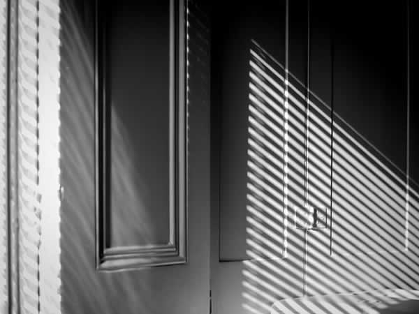 reflection of a window blind on a wall