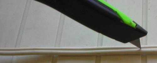 Utility knife blade in center of cable jacket